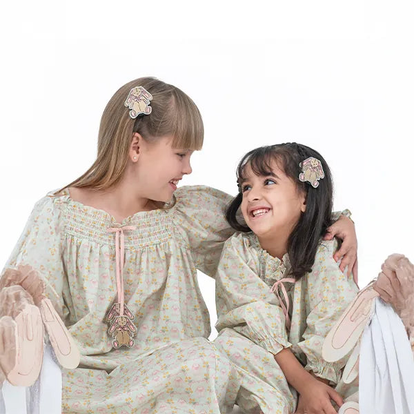 Two girls laughing together in matching Royal Pcs nightdresses