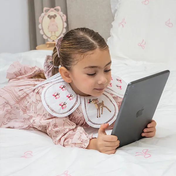 A girl in a smocked dress with a fawn collar